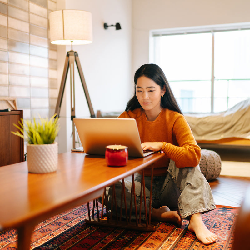 Woman on Laptop at Coffee table