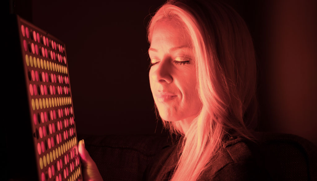 Woman using the TrueLight® Energy Square for facial skin health