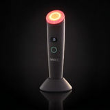 Perfectio X light therapy wand glowing red on a dramatic black background