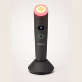 Perfectio X light therapy wand on its charging base, front view