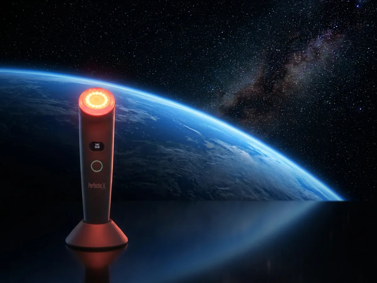 Perfectio X glowing in orbit above Earth, evoking its NASA-inspired LED light technology